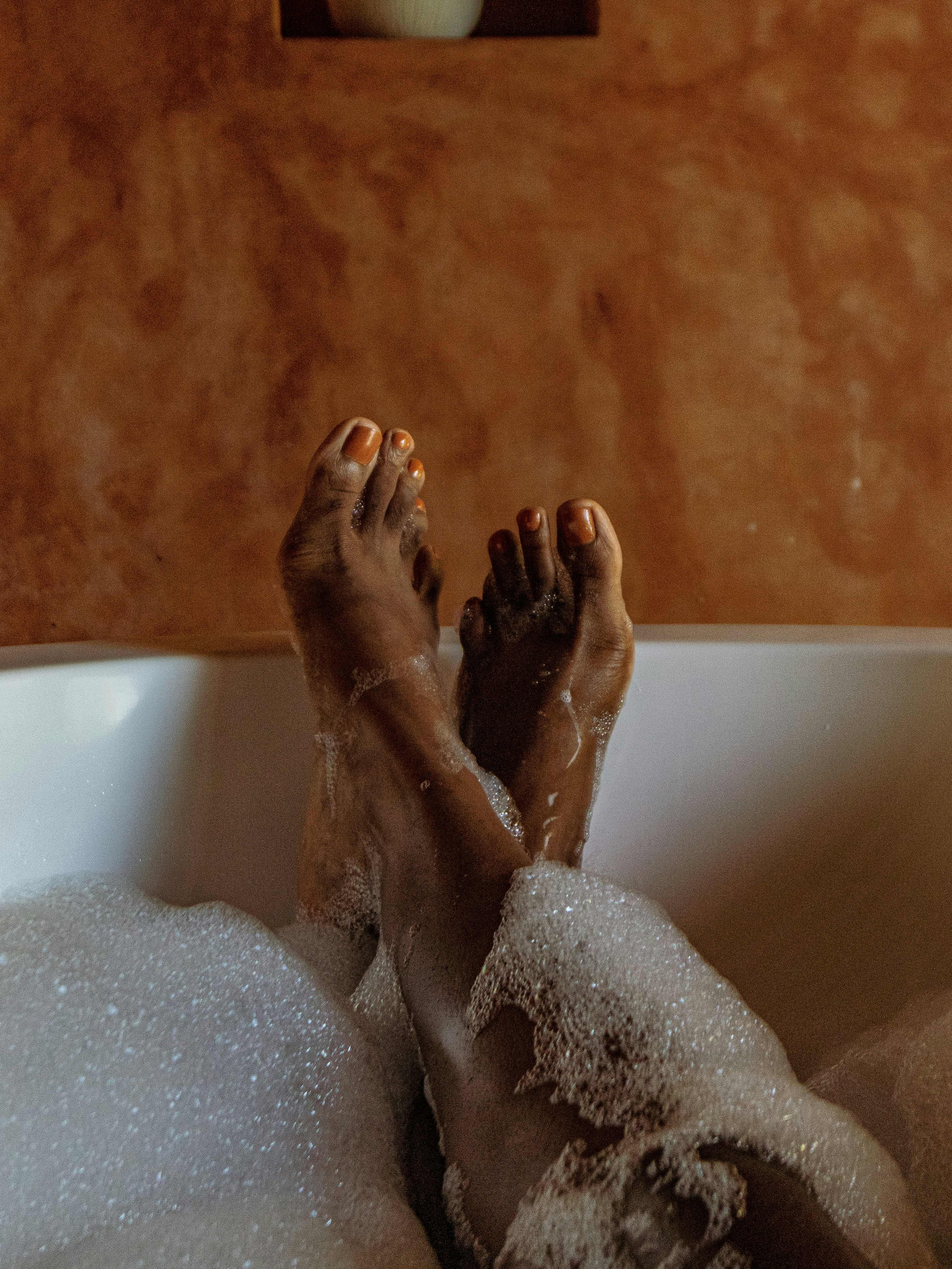 Relaxing in a warm bubble bath with terracotta walls